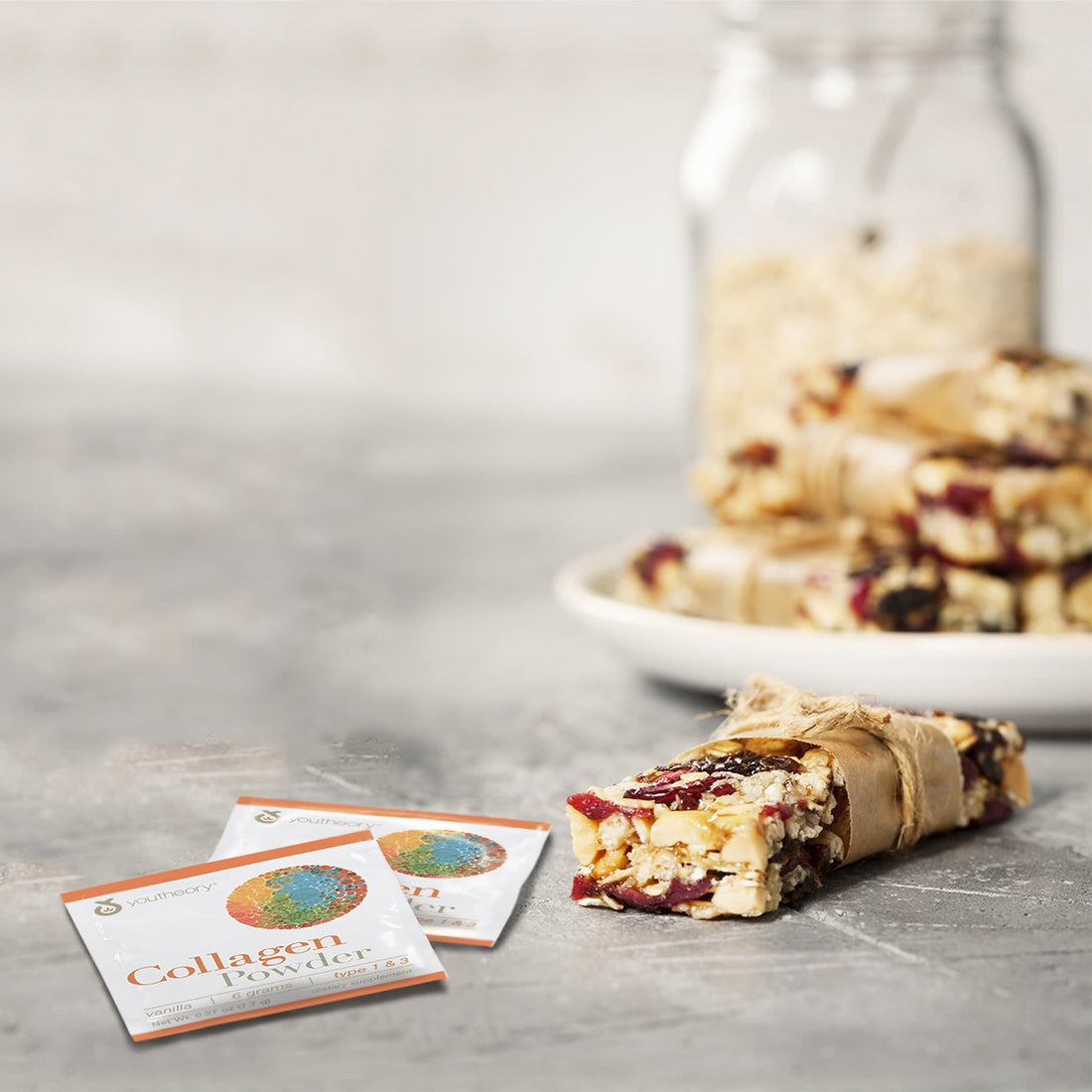 Collagen Powder packet next to Granola Bars