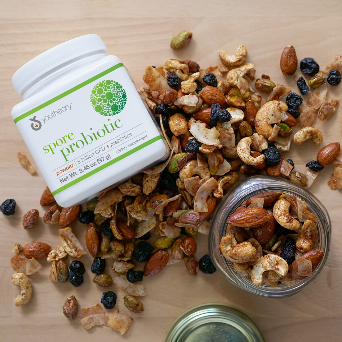 Spore Probiotic powder bottle next to Trail_Mix