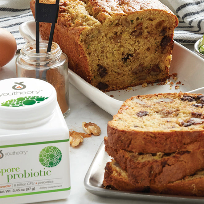 Spore Probiotic powder bottle next to Zucchini Bread